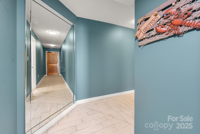 9550 Shore Dr Unit 930, Myrtle Beach, SC 29572 - hallway featuring baseboards, wood finished floors, and a textured ceiling