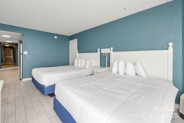 9550 Shore Dr Unit 930, Myrtle Beach, SC 29572 - bedroom with wood finished floors and a textured ceiling