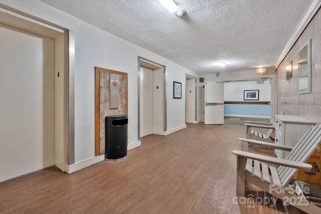 9550 Shore Dr Unit 930, Myrtle Beach, SC 29572 - corridor featuring wood finished floors, a textured ceiling, and elevator
