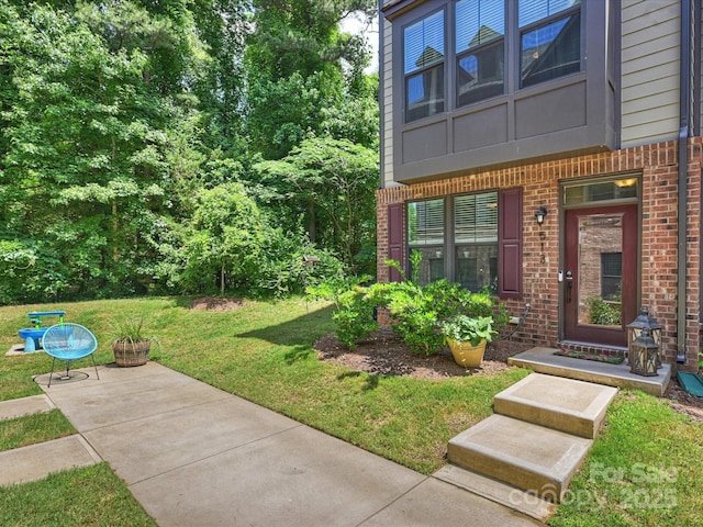 513 Cubitt Ct, Charlotte, NC 28205 - doorway to property with brick siding and a yard