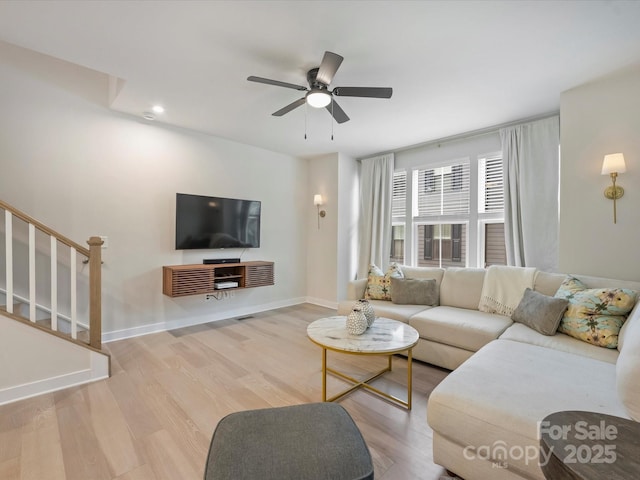 513 Cubitt Ct, Charlotte, NC 28205 - living area with stairway, wood finished floors, a ceiling fan, and baseboards