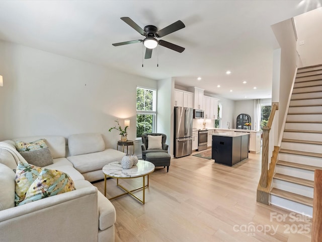 513 Cubitt Ct, Charlotte, NC 28205 - living room featuring healthy amount of natural light, stairway, light wood-style floors, recessed lighting, and ceiling fan