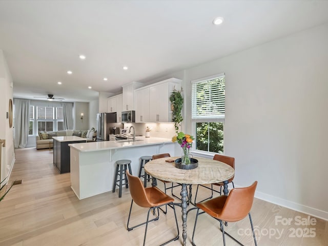 513 Cubitt Ct, Charlotte, NC 28205 - dining room featuring light wood-style floors, recessed lighting, baseboards, and a ceiling fan