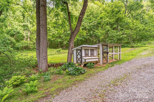 32 Evita Cove Rd, Weaverville, NC 28787 - view of property's community featuring exterior structure, a forest view, and an outbuilding