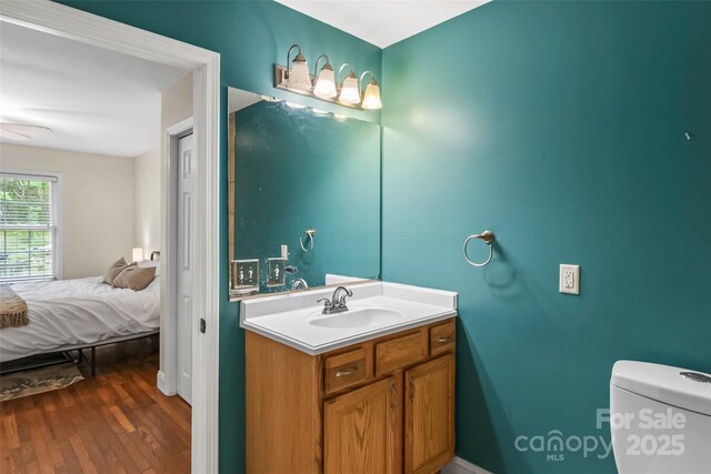 32 Evita Cove Rd, Weaverville, NC 28787 - ensuite bathroom with wood finished floors, vanity, toilet, a ceiling fan, and baseboards