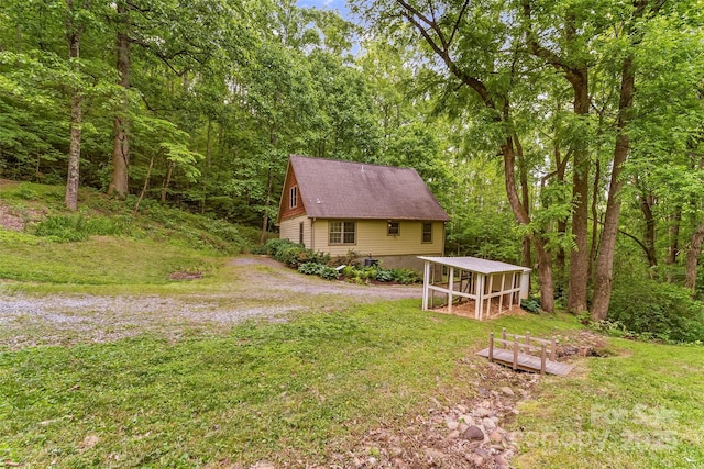32 Evita Cove Rd, Weaverville, NC 28787 - view of green lawn featuring an outbuilding, a forest view, and exterior structure