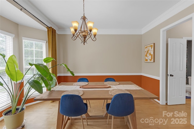 12303 Shadow Ridge Ln, Charlotte, NC 28273 - dining space with a chandelier, crown molding, breakfast area, baseboards, and light wood finished floors