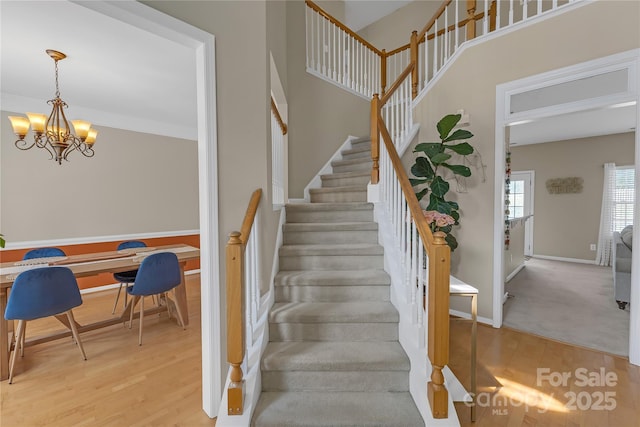 12303 Shadow Ridge Ln, Charlotte, NC 28273 - stairway with wood finished floors, a chandelier, and baseboards
