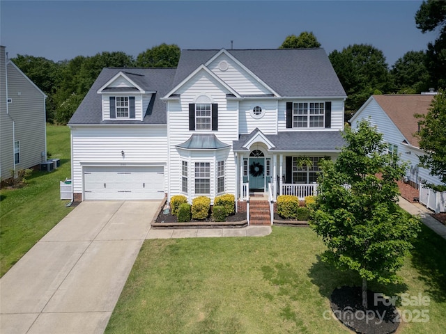 12303 Shadow Ridge Ln, Charlotte, NC 28273 - traditional-style house featuring driveway, a front yard, an attached garage, a shingled roof, and a porch