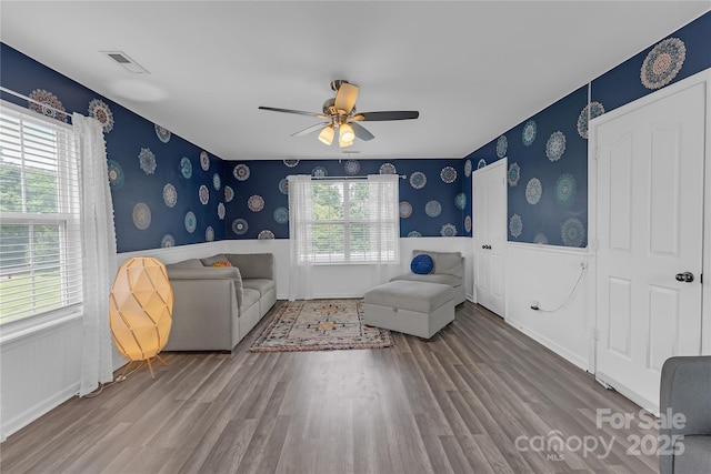 12303 Shadow Ridge Ln, Charlotte, NC 28273 - sitting room featuring wood finished floors, a wainscoted wall, wallpapered walls, and a ceiling fan