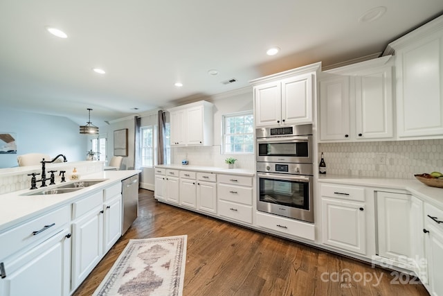 1121 S Wendover Rd, Charlotte, NC 28211 - kitchen with a sink, appliances with stainless steel finishes, backsplash, ornamental molding, and white cabinetry
