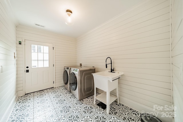 1121 S Wendover Rd, Charlotte, NC 28211 - laundry area featuring washing machine and dryer, wooden walls, and ornamental molding