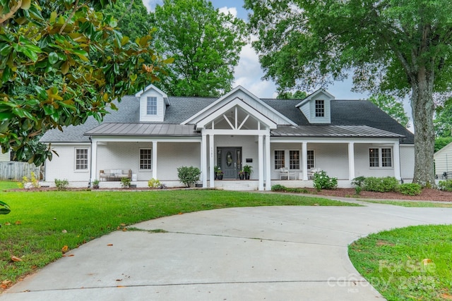 1121 S Wendover Rd, Charlotte, NC 28211 - view of front facade with a porch, a front yard, a standing seam roof, brick siding, and metal roof
