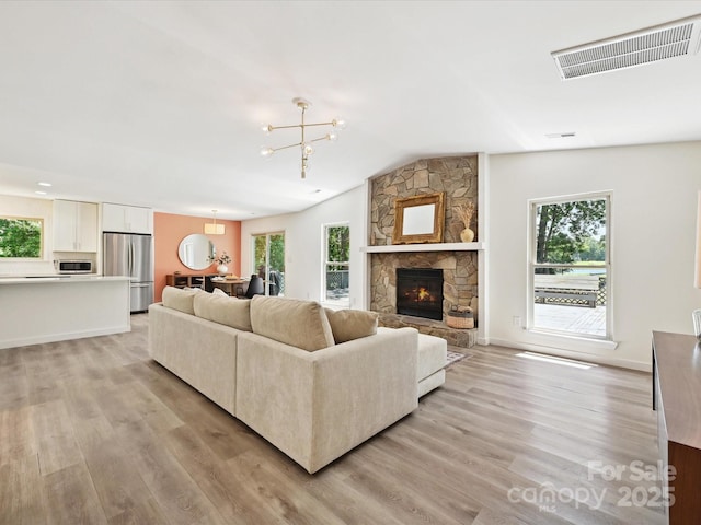 3531 Bon Rea Dr, Charlotte, NC 28226 - living room with light wood-style floors, healthy amount of natural light, a fireplace, and lofted ceiling