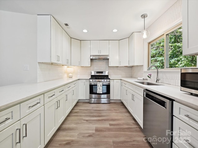 3531 Bon Rea Dr, Charlotte, NC 28226 - kitchen with stainless steel appliances, a sink, under cabinet range hood, white cabinets, and recessed lighting