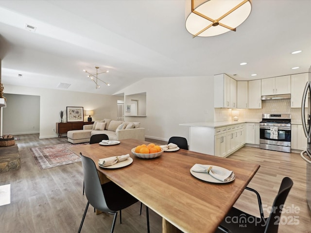 3531 Bon Rea Dr, Charlotte, NC 28226 - dining area with lofted ceiling, light wood-style flooring, baseboards, a chandelier, and recessed lighting