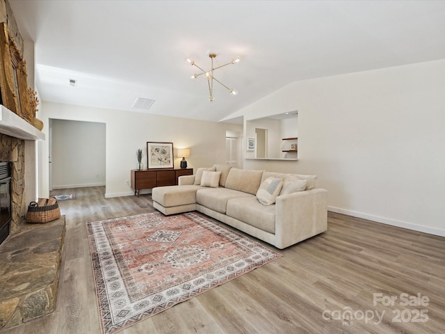 3531 Bon Rea Dr, Charlotte, NC 28226 - living room with wood finished floors, a fireplace, lofted ceiling, a chandelier, and baseboards