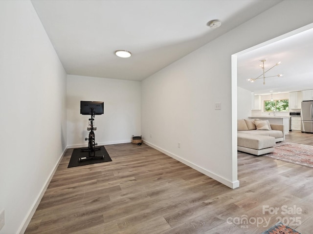 3531 Bon Rea Dr, Charlotte, NC 28226 - exercise area with light wood-type flooring, baseboards, and a chandelier