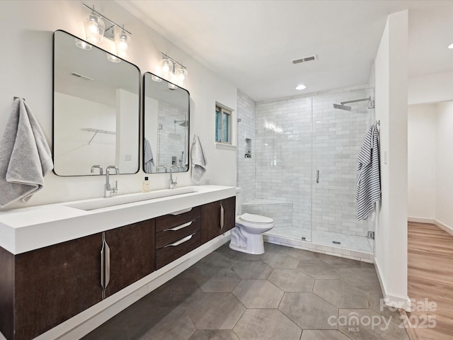 3531 Bon Rea Dr, Charlotte, NC 28226 - full bathroom with double vanity, a stall shower, toilet, and recessed lighting