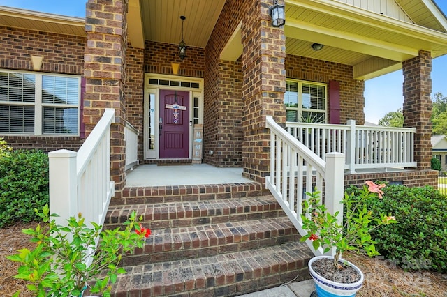 141 Tall Fern Loop, Mooresville, NC 28117 - entrance to property featuring covered porch, brick siding, and board and batten siding