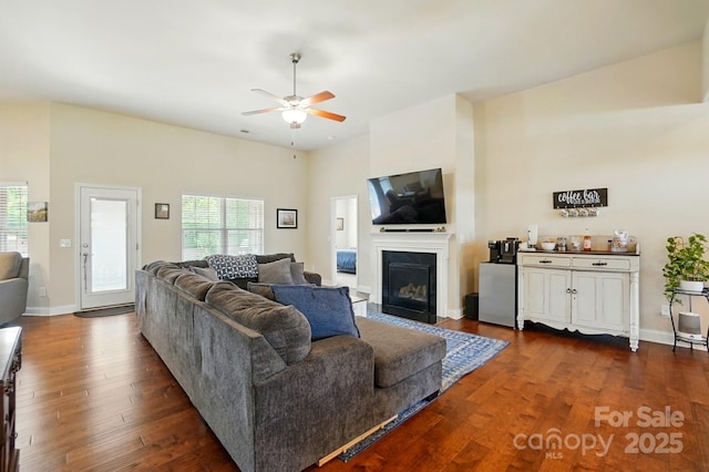 141 Tall Fern Loop, Mooresville, NC 28117 - living room with a ceiling fan, dark wood-style floors, a glass covered fireplace, and baseboards