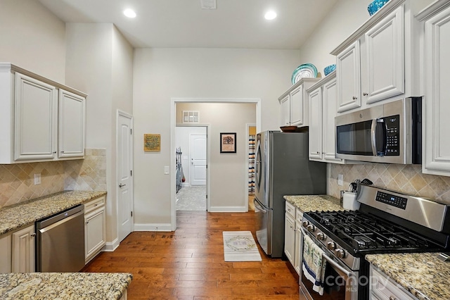 141 Tall Fern Loop, Mooresville, NC 28117 - kitchen with appliances with stainless steel finishes, dark wood-style floors, light stone counters, recessed lighting, and backsplash