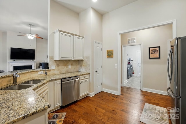141 Tall Fern Loop, Mooresville, NC 28117 - kitchen with appliances with stainless steel finishes, a sink, a ceiling fan, backsplash, and dark wood-type flooring