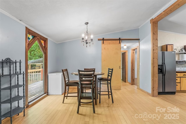 42 Evita Cove Rd, Weaverville, NC 28787 - dining room featuring ornamental molding, a barn door, a chandelier, and light wood finished floors