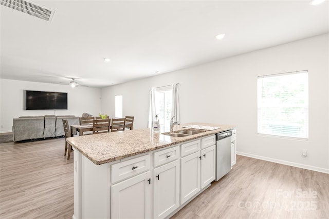 2340 Lanza Dr, Charlotte, NC 28215 - kitchen featuring dishwasher, light wood-style floors, ceiling fan, a sink, and a center island with sink
