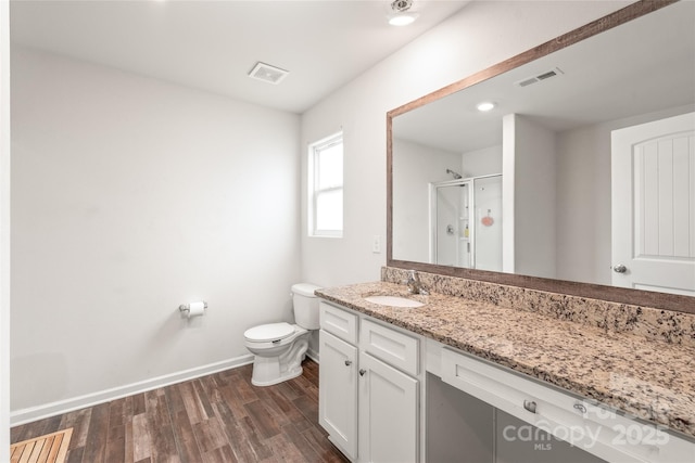 2340 Lanza Dr, Charlotte, NC 28215 - bathroom featuring baseboards, vanity, toilet, wood finished floors, and a shower stall