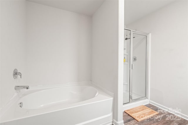 2340 Lanza Dr, Charlotte, NC 28215 - full bathroom with a shower stall, a garden tub, wood finished floors, and baseboards