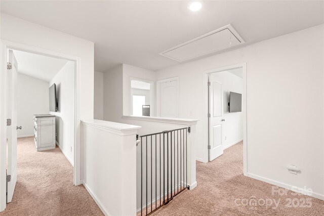 2340 Lanza Dr, Charlotte, NC 28215 - hallway featuring attic access, light carpet, an upstairs landing, and baseboards