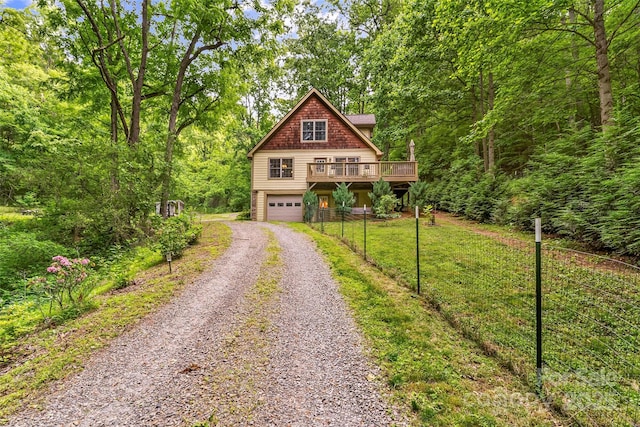 32 Evita Cove Rd, Weaverville, NC 28787 - view of front of property with gravel driveway, a garage, a wooden deck, and a forest view