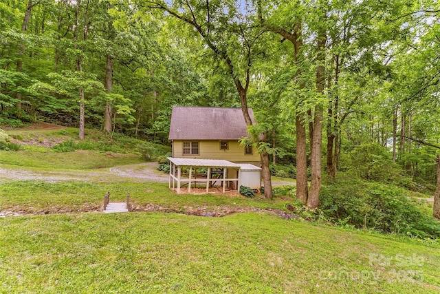 32 Evita Cove Rd, Weaverville, NC 28787 - rear view of property featuring a lawn, an outbuilding, and a forest view