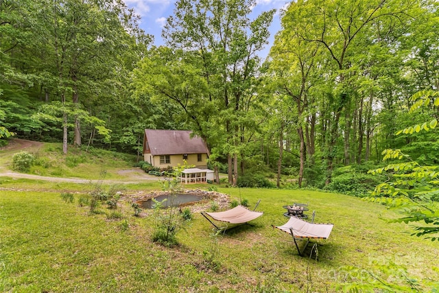 32 Evita Cove Rd, Weaverville, NC 28787 - view of green lawn with a wooded view and an outbuilding
