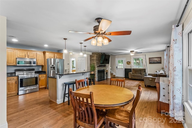 32 Evita Cove Rd, Weaverville, NC 28787 - dining room featuring ceiling fan, light wood finished floors, a fireplace, and recessed lighting
