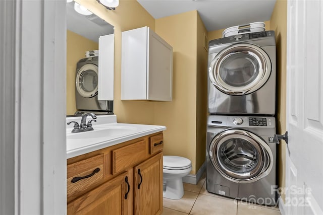 32 Evita Cove Rd, Weaverville, NC 28787 - bathroom with stacked washer and clothes dryer, tile patterned flooring, vanity, and toilet