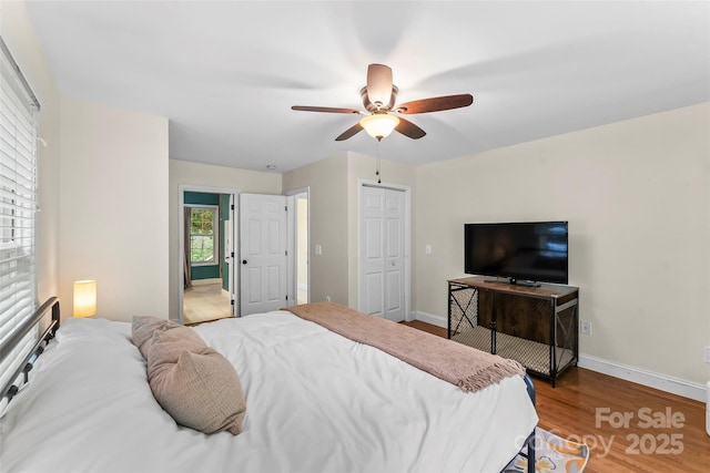 32 Evita Cove Rd, Weaverville, NC 28787 - bedroom featuring baseboards, wood finished floors, a ceiling fan, and a closet