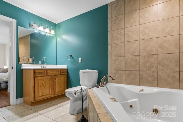 32 Evita Cove Rd, Weaverville, NC 28787 - bathroom featuring toilet, a jetted tub, vanity, tile patterned flooring, and baseboards