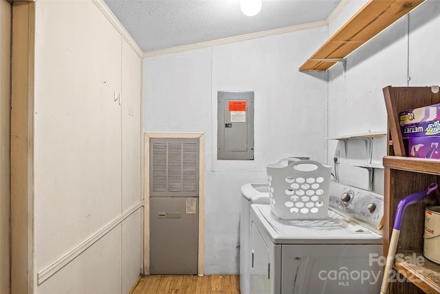 32 Evita Cove Rd, Weaverville, NC 28787 - washroom featuring electric panel, washing machine and clothes dryer, ornamental molding, a heating unit, and light wood-style flooring