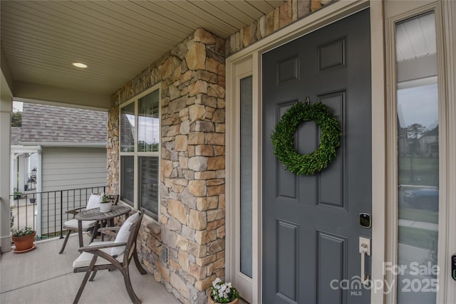 15216 Shallow Ridge Rd, Charlotte, NC 28278 - view of exterior entry featuring a porch and stone siding