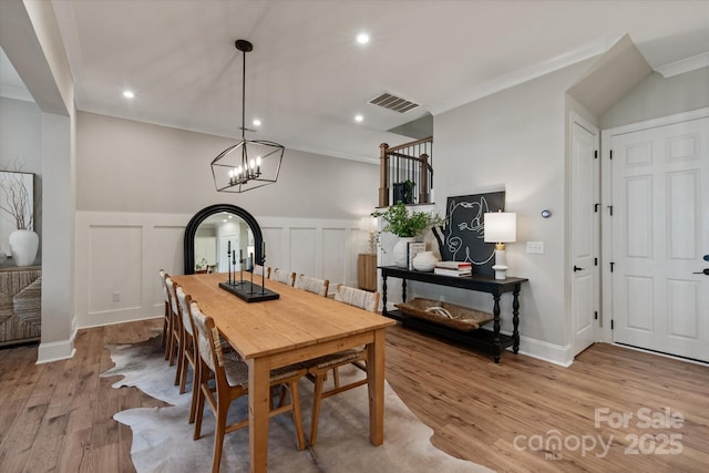 20216 Shaffer Bach Ln, Charlotte, NC 28277 - dining space featuring wood finished floors, recessed lighting, wainscoting, a chandelier, and a decorative wall