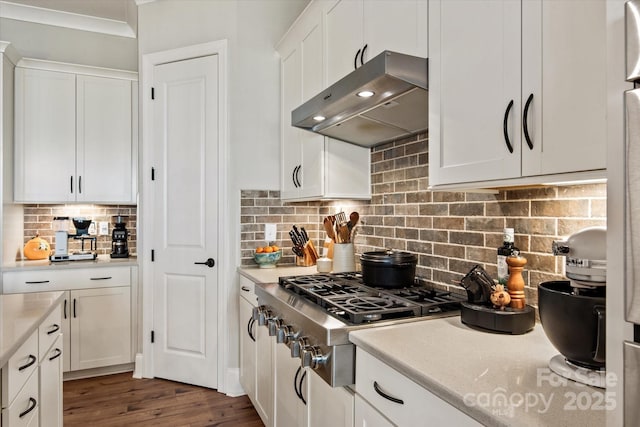 20216 Shaffer Bach Ln, Charlotte, NC 28277 - kitchen with under cabinet range hood, stainless steel gas cooktop, white cabinets, decorative backsplash, and dark wood-style flooring