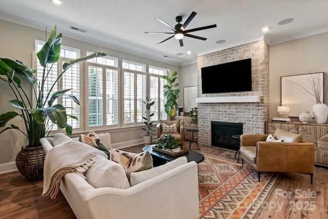 20216 Shaffer Bach Ln, Charlotte, NC 28277 - living area featuring wood finished floors, a brick fireplace, a ceiling fan, ornamental molding, and baseboards