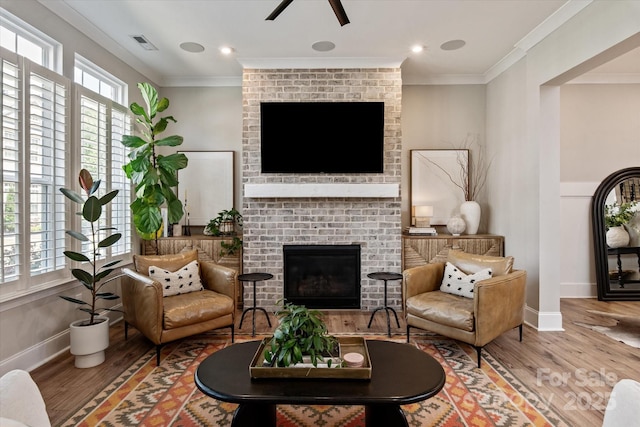 20216 Shaffer Bach Ln, Charlotte, NC 28277 - living area featuring a fireplace, wood finished floors, ceiling fan, ornamental molding, and baseboards