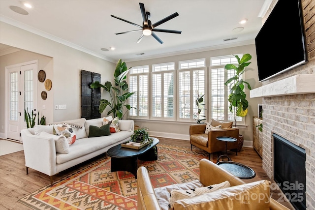 20216 Shaffer Bach Ln, Charlotte, NC 28277 - living room with a fireplace, wood finished floors, ornamental molding, a ceiling fan, and plenty of natural light
