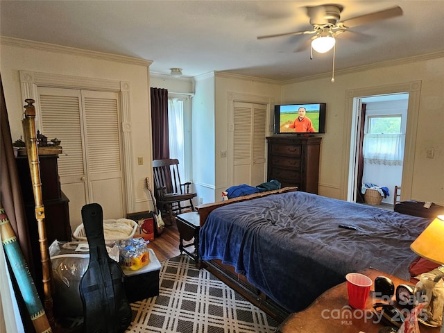 368 Settlemyre Rd, Morganton, NC 28655 - bedroom featuring multiple closets, ornamental molding, wood finished floors, and a ceiling fan