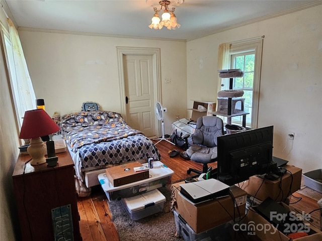 368 Settlemyre Rd, Morganton, NC 28655 - bedroom featuring hardwood / wood-style floors, ornamental molding, and a chandelier
