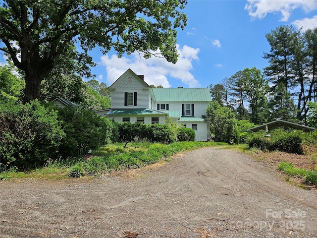 368 Settlemyre Rd, Morganton, NC 28655 - view of front of home with dirt driveway, metal roof, and a chimney