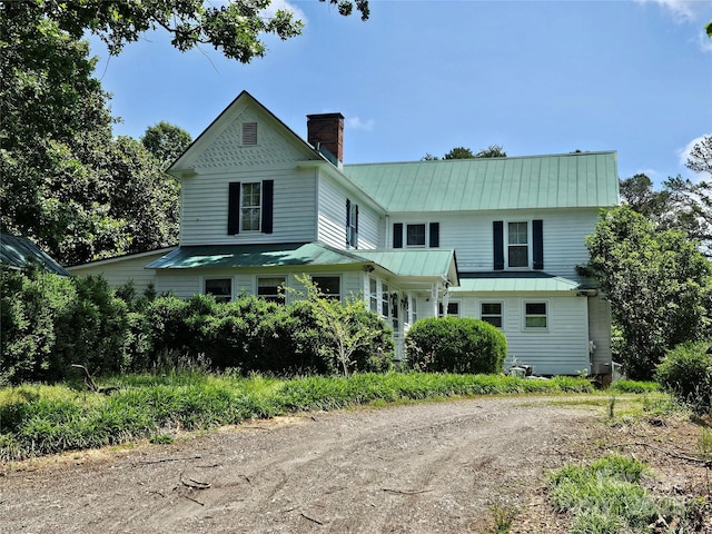 368 Settlemyre Rd, Morganton, NC 28655 - view of front of home featuring a chimney, dirt driveway, and metal roof